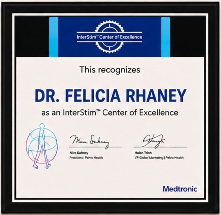 Framed Medtronic InterStim Center of Excellence plaque recognizing Dr. Felicia Rhaney, in a black frame.